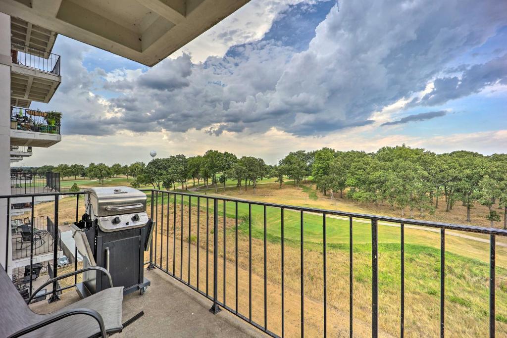 a grill on a balcony with a view of a field at Golf Course and Lake Views Cozy Afton Condo! in Afton