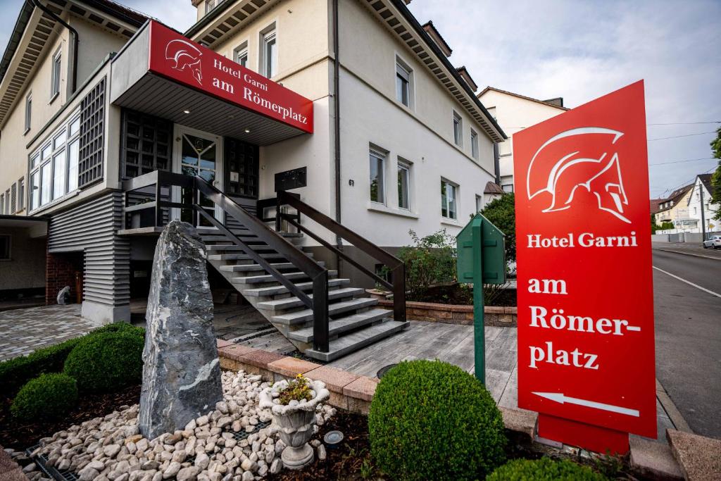a building with a red sign in front of it at Hotel am Römerplatz in Ulm