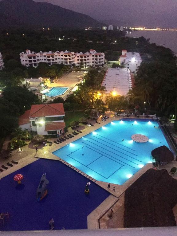 an overhead view of a large swimming pool at night at Costa Azul Suites 1002 in Santa Marta
