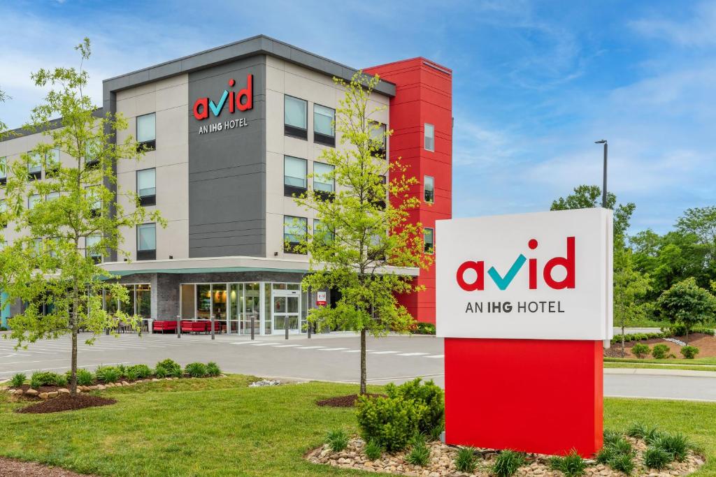 an mg hotel sign in front of a building at avid hotel Nashville - Lebanon an IHG Hotel in Lebanon