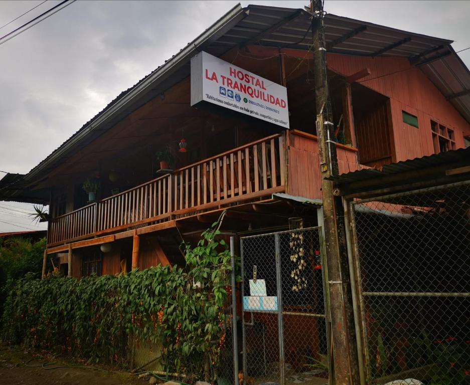 a house with a sign on the side of it at LA TRANQUILIDAD in Mindo