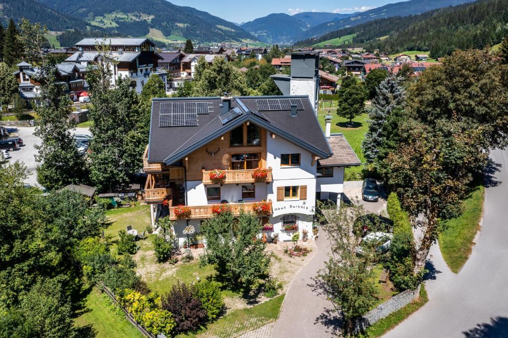 an aerial view of a house with solar panels on the roof at Bee happy Haus Burböck in Flachau