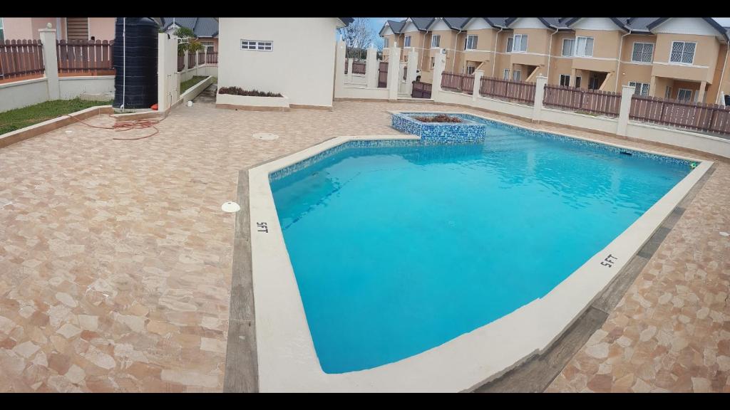 a large blue swimming pool in front of a building at de Felice in Mount Pleasant