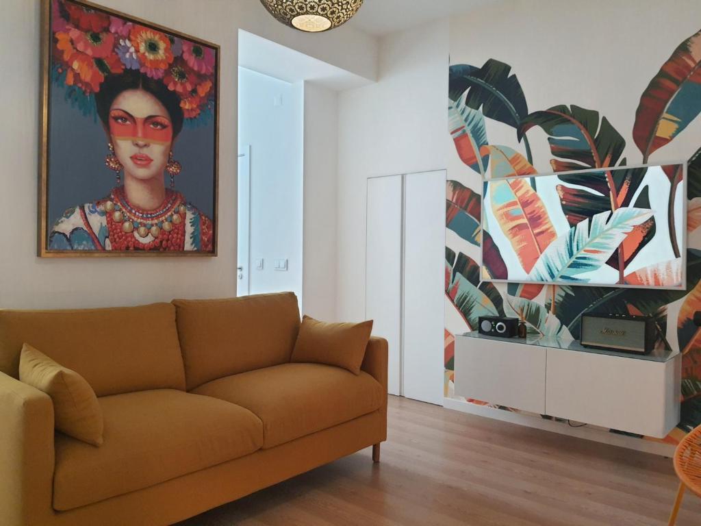 a living room with a couch and a painting on the wall at Exotic Fusion: Coffee & Radio in Lisbon