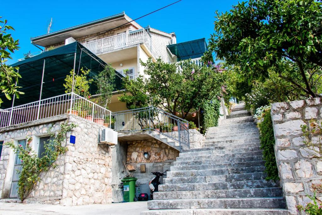 a set of stairs in front of a building at Apartments with a parking space Trpanj, Peljesac - 11545 in Trpanj