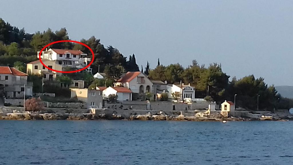 a house on a island in the water at Apartments by the sea Prvic Luka, Prvic - 13845 in Prvić Luka