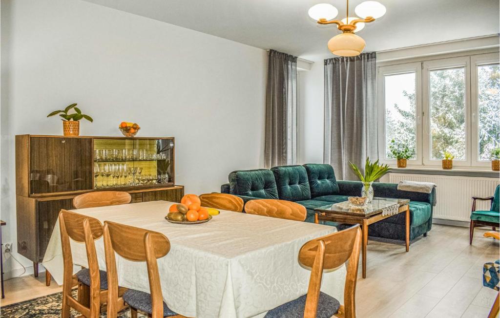 a living room with a table and a couch at Awesome Apartment In Darlowo With Kitchen in Darłowo