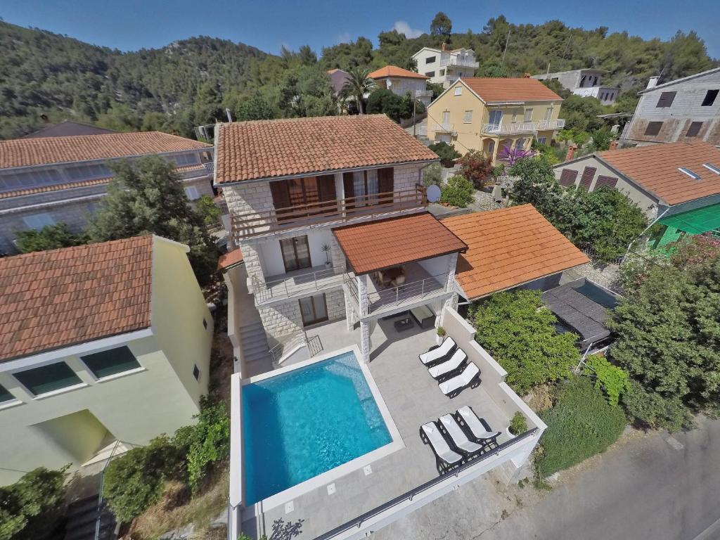 an aerial view of a house with a swimming pool at Family friendly house with a swimming pool Brna, Korcula - 13943 in Smokvica