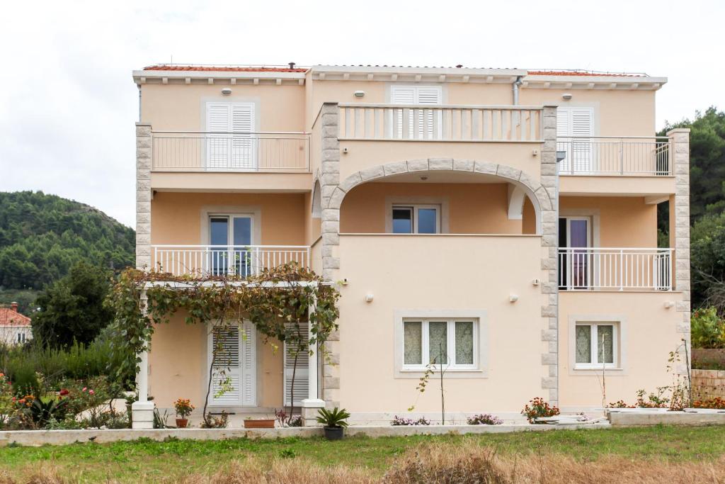 a house with a balcony on the side of it at Apartments and rooms by the sea Lopud, Elafiti - 14013 in Lopud