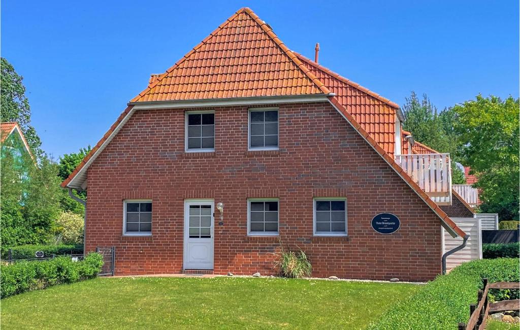 a red brick house with an orange roof at Sanddorn in Gollwitz