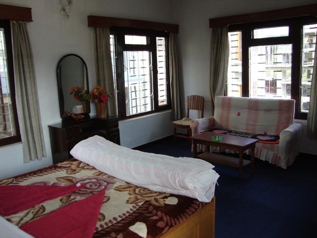Ένα ή περισσότερα κρεβάτια σε δωμάτιο στο New Summit Guest House