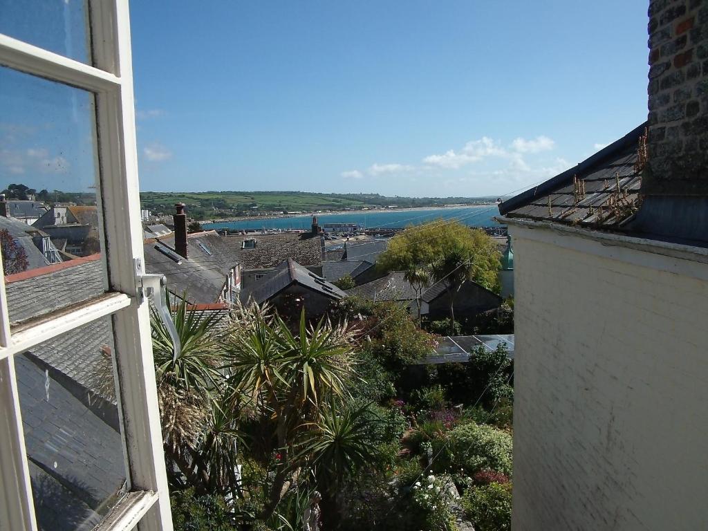 a view of the ocean from a window of a building at Sea View in Penzance