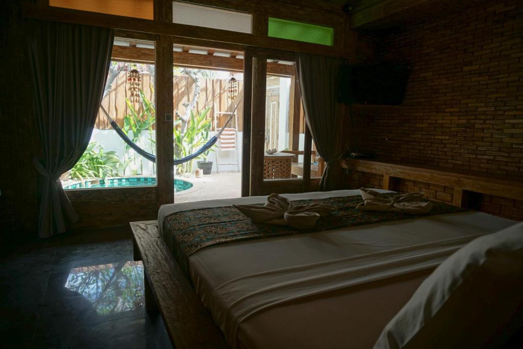 Postel nebo postele na pokoji v ubytování Jawa House Private Villas