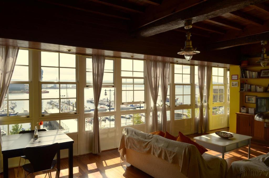 a living room with a couch and a large window at A Pousada do Mar Ferrol in Ferrol