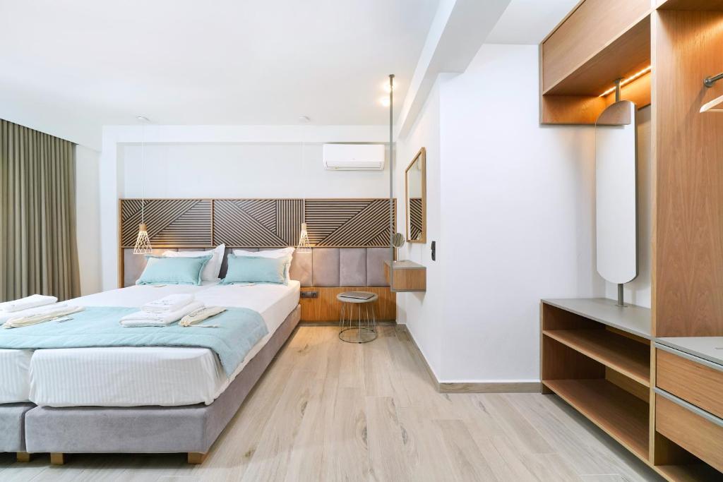 een slaapkamer met een groot bed en een televisie bij Elisavet Nuevo Studios & Suites in Skala Potamias