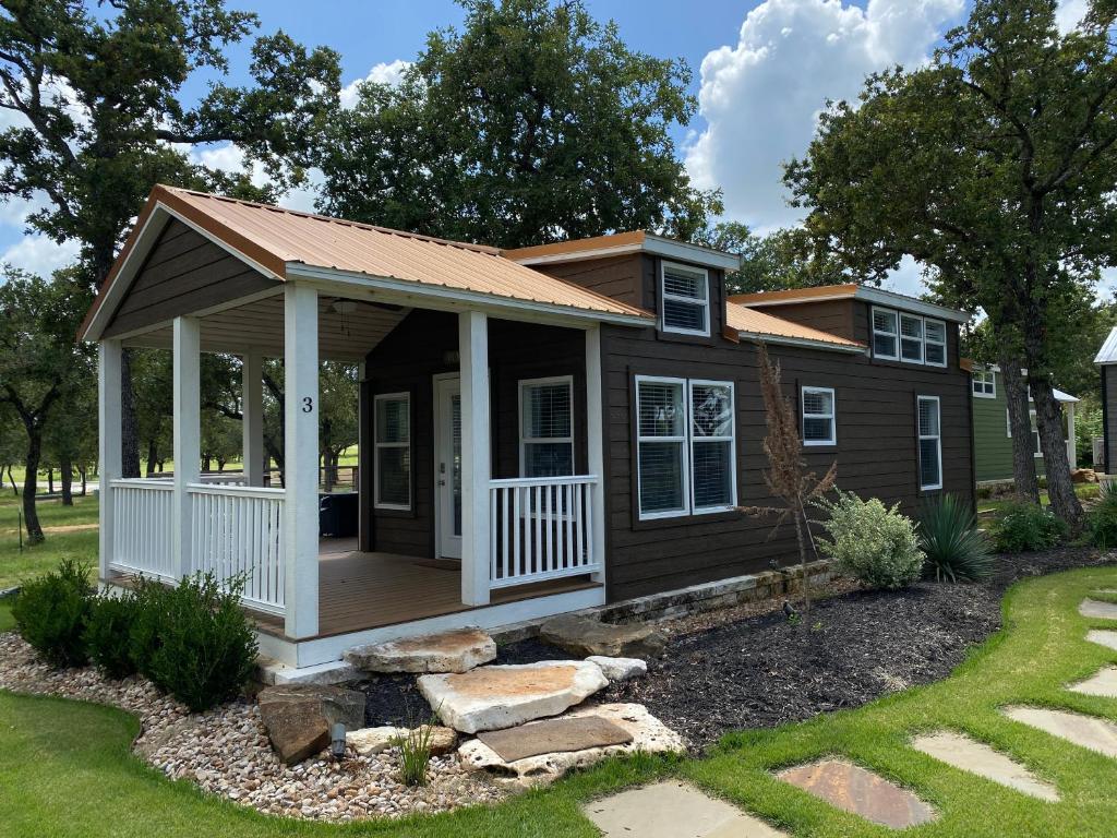 a tiny house with a porch and a deck at Cozy Tiny Home with Patio - 1 Mile to Town in Fredericksburg