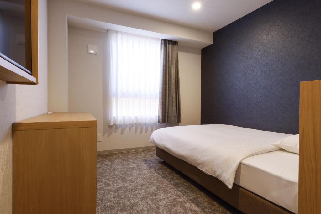 Postel nebo postele na pokoji v ubytování Plum Hotel
