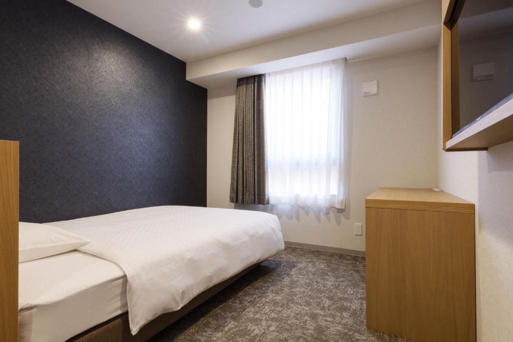 Postel nebo postele na pokoji v ubytování Plum Hotel