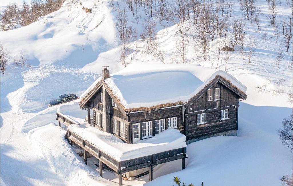 a house covered in snow in the snow at Stunning Home In Tjrhom With Wifi And 8 Bedrooms in Tjørhom