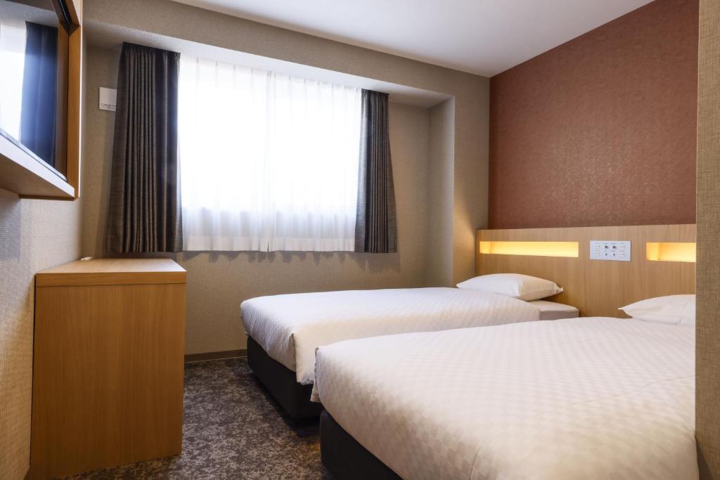 Postel nebo postele na pokoji v ubytování Plum Hotel