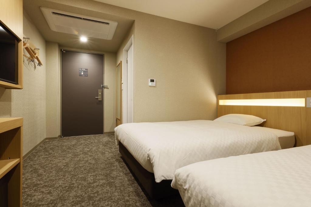 Postel nebo postele na pokoji v ubytování Plum Hotel