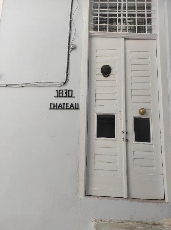 a white door on the side of a building at 1830 Chateau in Nafplio