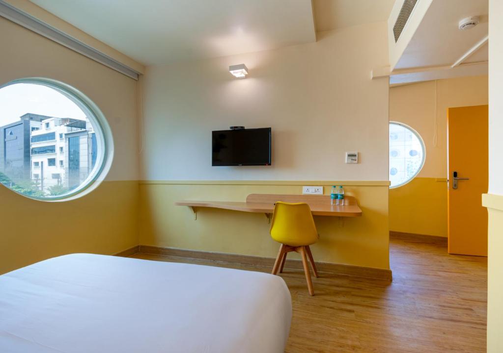 Postel nebo postele na pokoji v ubytování Bloom Hotel - HITEC City