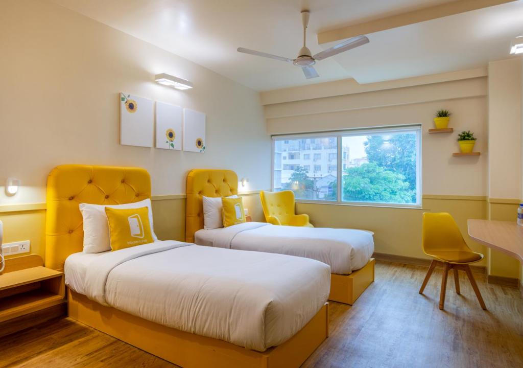 Postel nebo postele na pokoji v ubytování Bloom Hotel - HITEC City