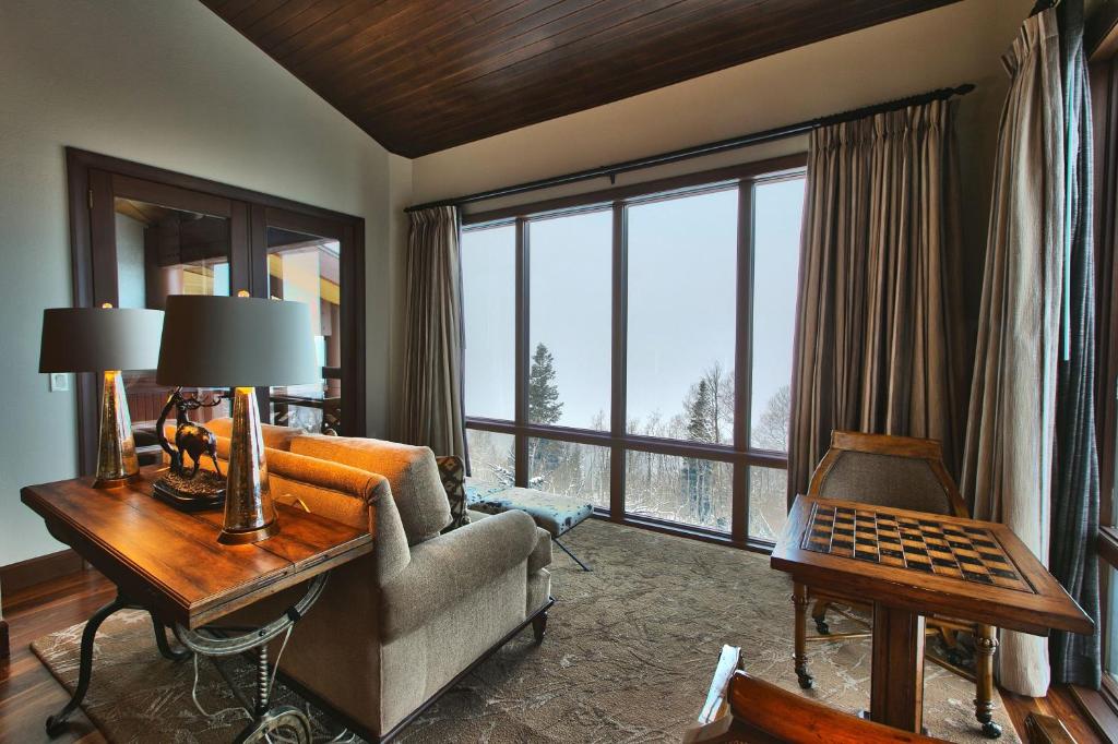 a living room with a couch and a large window at Premium Luxury Three Bedroom Suite with Two Hot Tubs apartment hotel in Park City