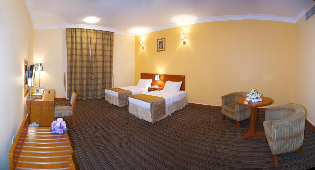 Postel nebo postele na pokoji v ubytování Al Massa Plus Hotel