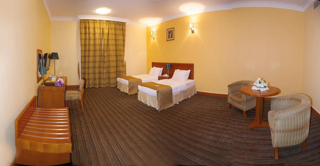 Postel nebo postele na pokoji v ubytování Al Massa Plus Hotel