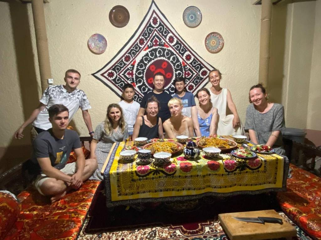 a group of people posing in front of a table at Hotel Han in Samarkand