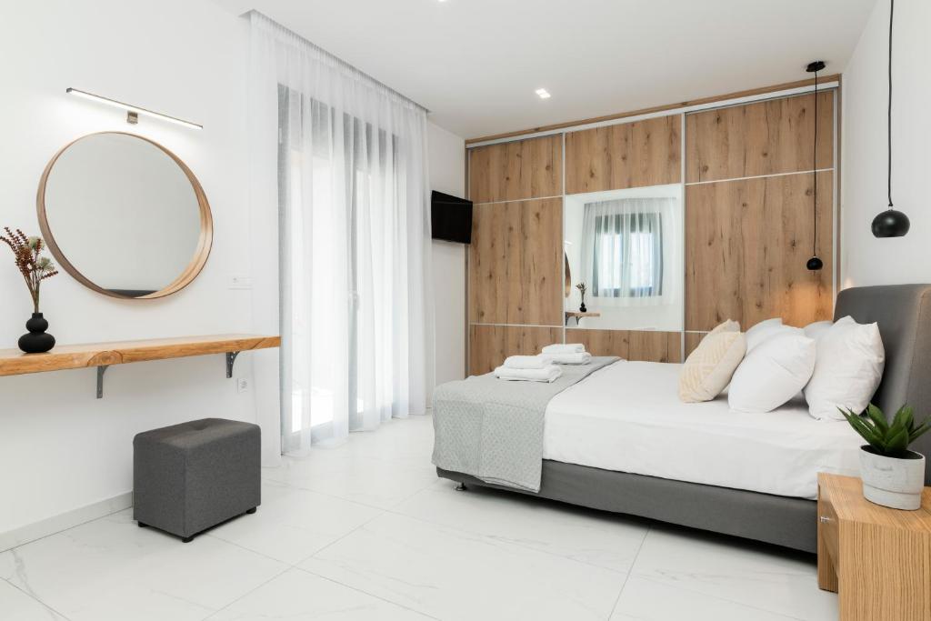 a bedroom with a large bed and a mirror at Eagle's Nest - Adjoining Villas! in Tsilivi