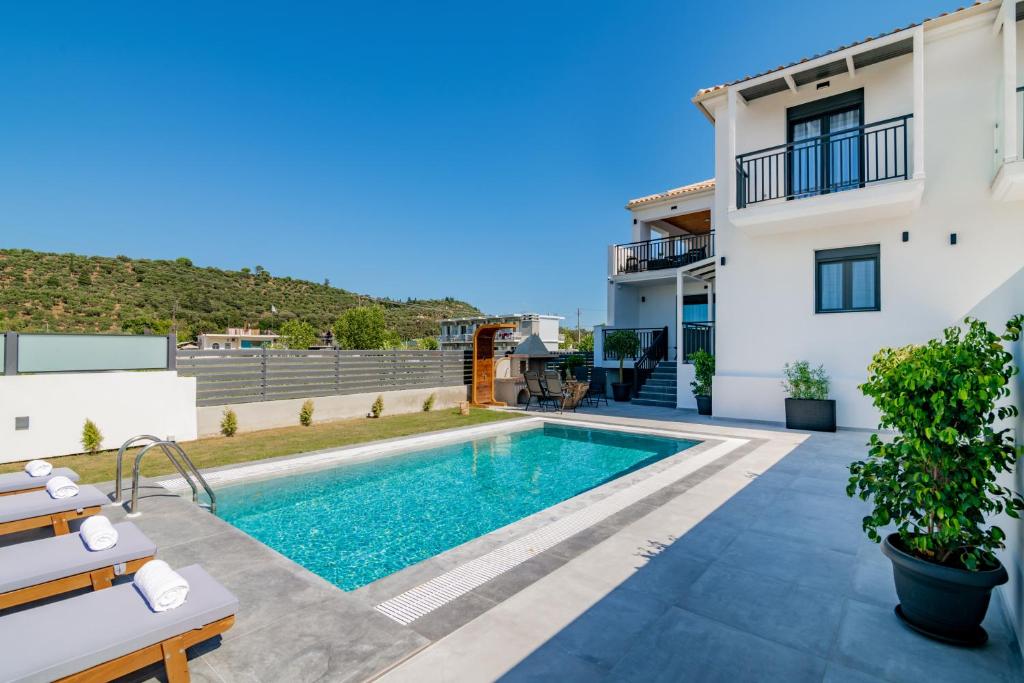 a villa with a swimming pool and a house at Eagle's Nest - Adjoining Villas! in Tsilivi