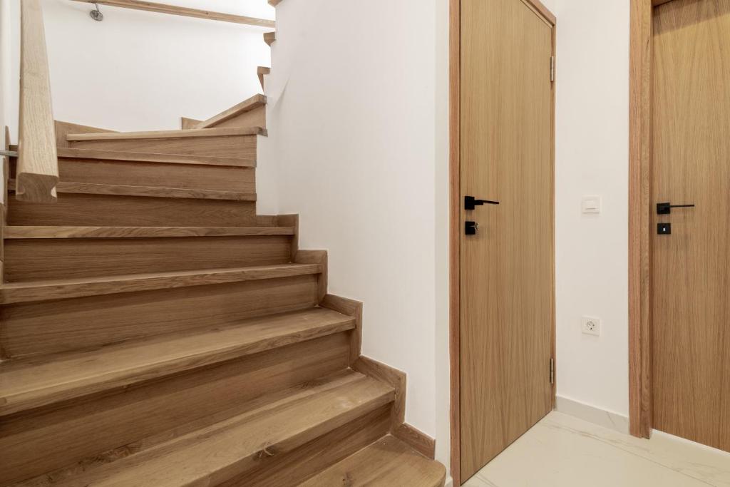 a staircase in a house with wooden floors at Eagle's Nest - Adjoining Villas! in Tsilivi