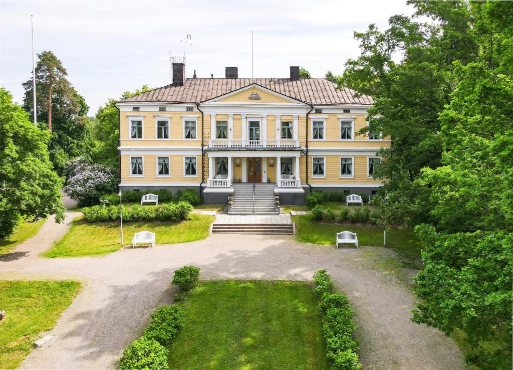 an aerial view of a large yellow house at Sannäsin Kartano in Porvoo