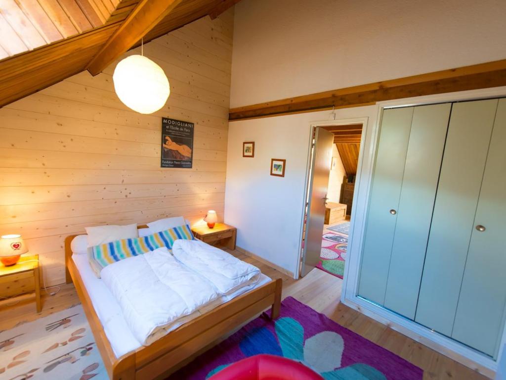 a bedroom with a bed in a wooden room at Appartement Saint-Chaffrey , 3 pièces, 6 personnes - FR-1-330E-106 in Saint-Chaffrey