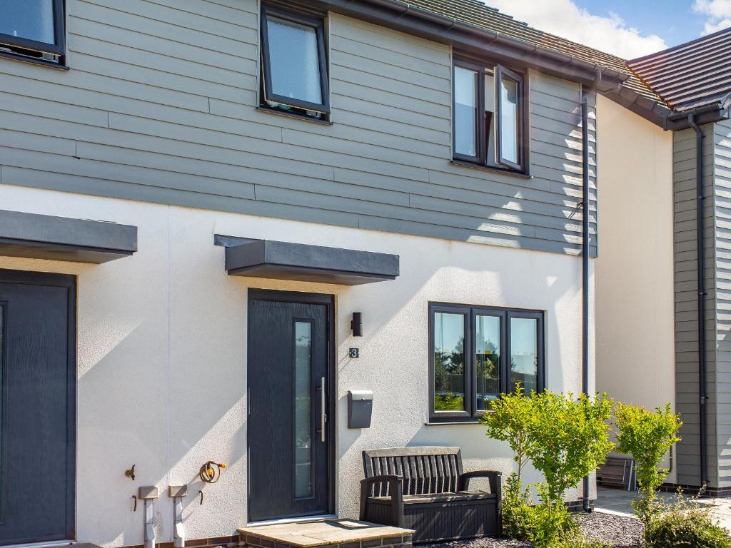 a house with a black door and black windows at Sea View in Rhosneigr