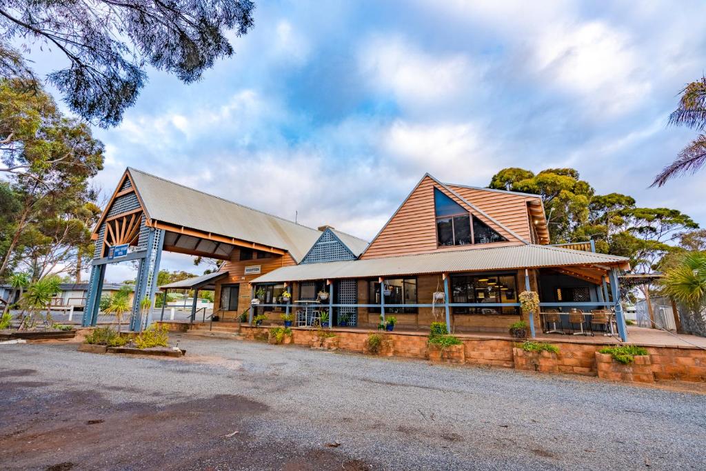 a large building with a gambrel roof at Great Western Motel Norseman in Norseman