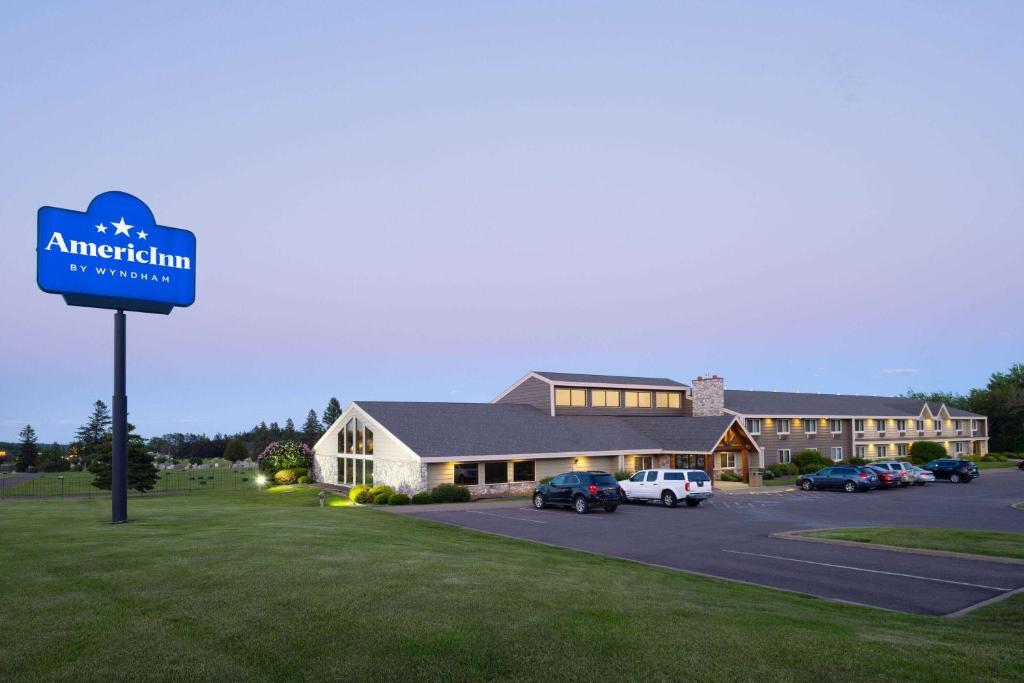 a hotel sign in front of a building at AmericInn by Wyndham Two Harbors Near Lake Superior in Two Harbors