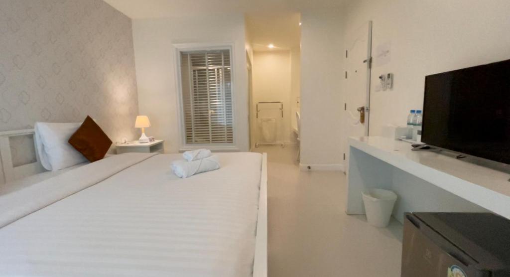 Postel nebo postele na pokoji v ubytování Shunli Hotel - SHA Extra Plus