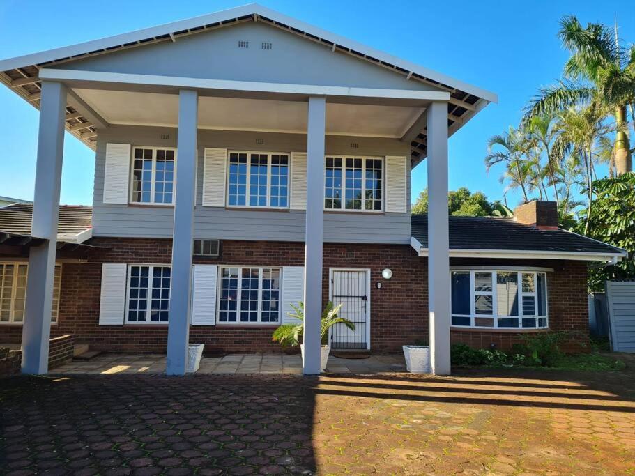 a brick house with a pavilion in front of it at African Cycad Holiday Home in Durban