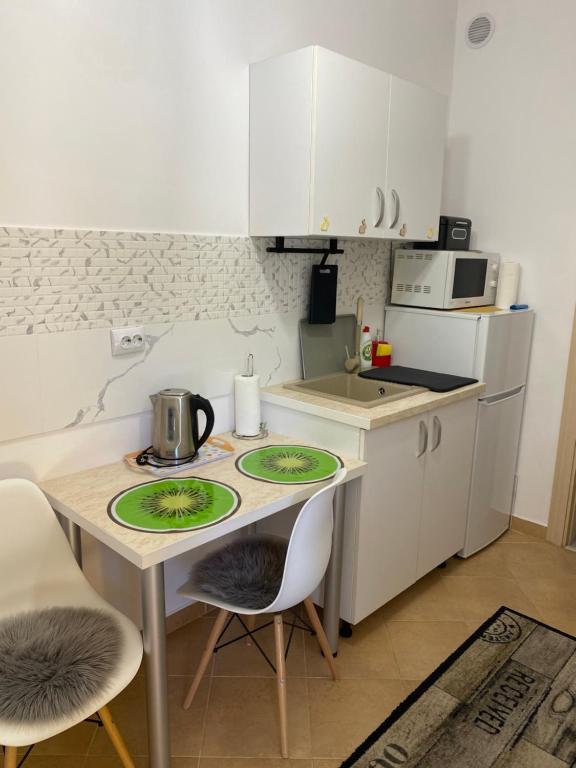 uma pequena cozinha com uma mesa e duas cadeiras em Magic Belleview Sinaia em Sinaia