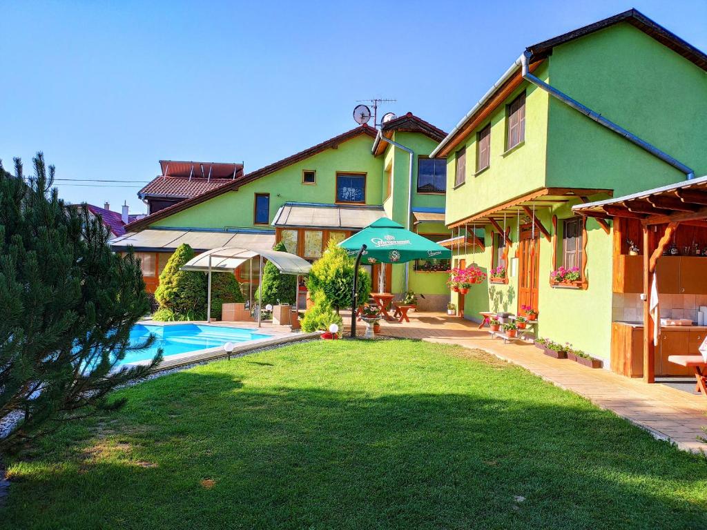 a house with a yard with a swimming pool at Villa Real Paradise in Smižany