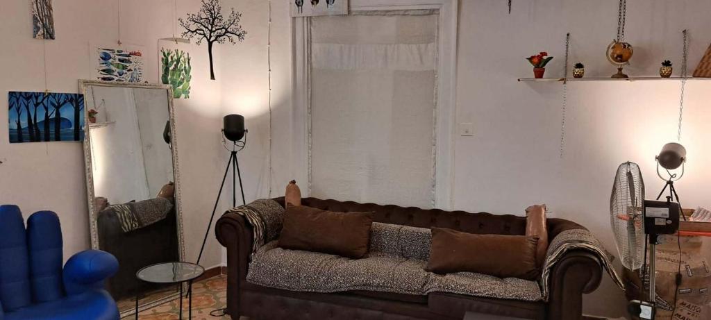 a living room with a couch and a window at Exclusive Dependance in Palermo