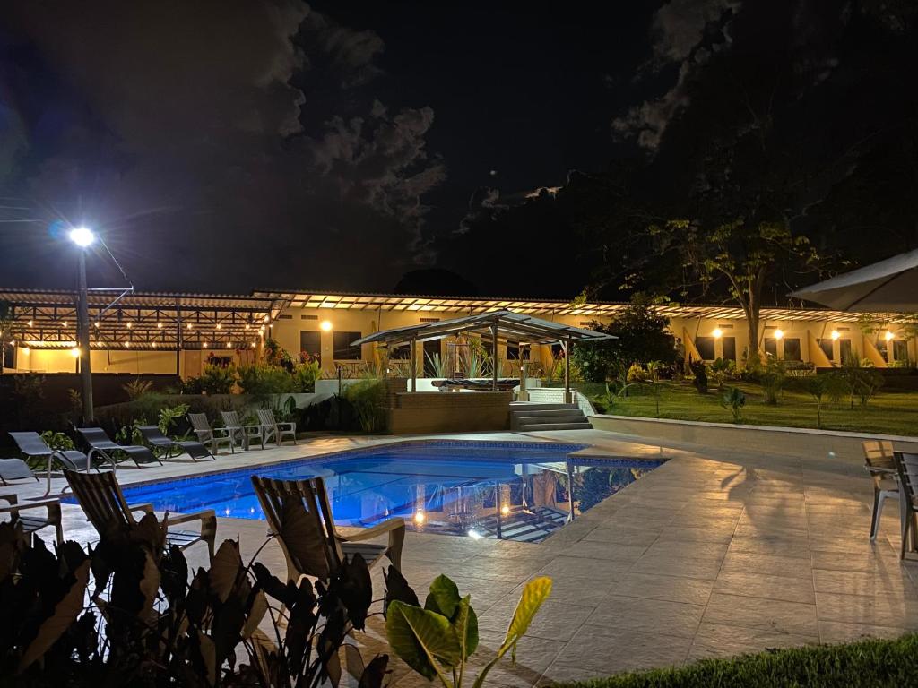 a house with a swimming pool at night at Baum Hotel in Armenia