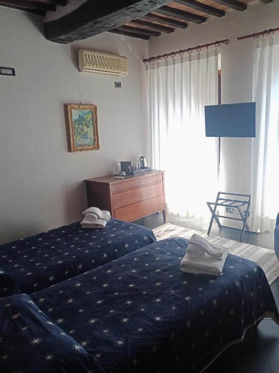 Posteľ alebo postele v izbe v ubytovaní Locanda del Glicine