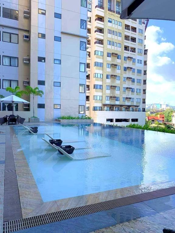 a swimming pool with two boats in the middle of a building at City View at The Persimmon Studios in Cebu City