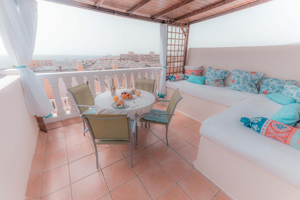a living room with a table and a couch at La sonada bright penthouse with views in Callao Salvaje