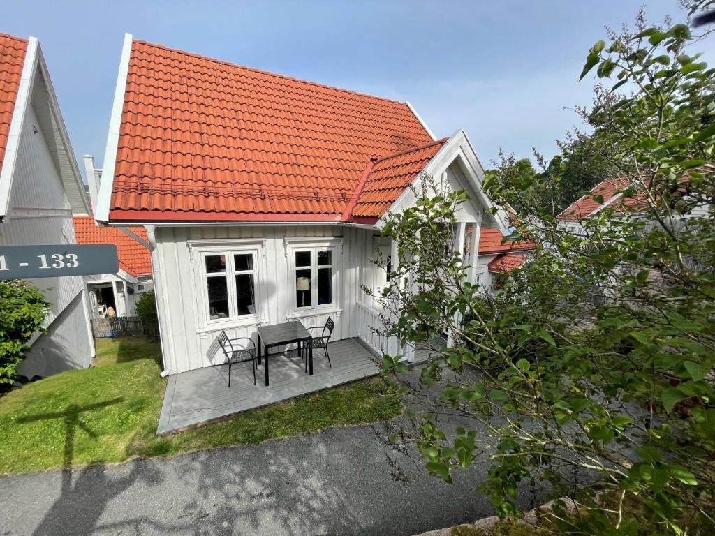 a small white house with an orange roof at Holmsbu cabin 133 - cabin close to the sea in Asker